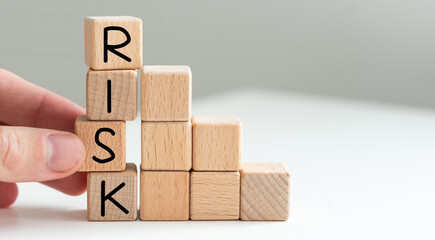 Financial risk assessment, risk reward and portfolio risk management concept. Blocks of wood cubes...