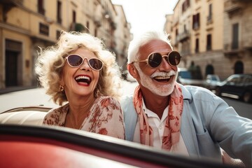 Happy old couple driving an old timer through an Italian town on their vacation.
