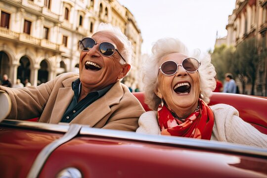 Happy old couple driving an old timer through an Italian town on their vacation.
