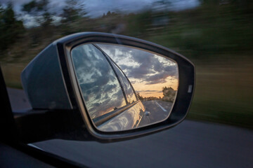 Sunset in car mirror, reflection from the nature