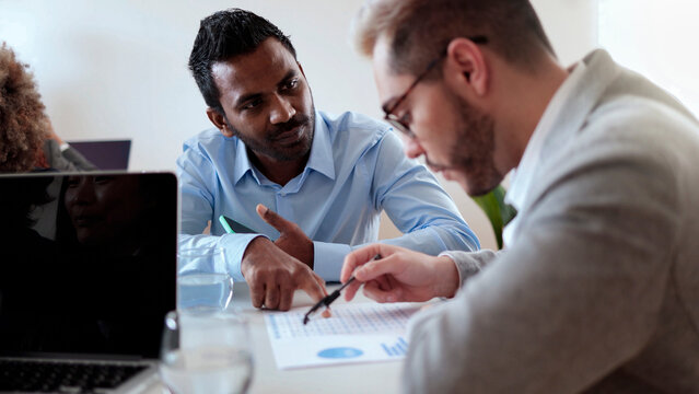 Multiethnic business people working at bank office analyzing data - Entrepreneur financial concept - Focus on Indian man face