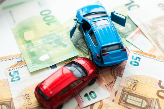 traffic accident of two toy cars in a european banknote background 