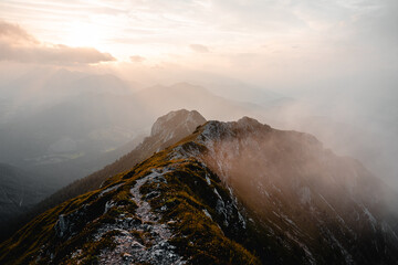 Embrace the ethereal beauty of nature's finest hour as the sun gracefully descends beyond the horizon, casting a warm, golden glow upon the majestic mountains. the power of green nature.