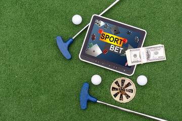 Casino chips and golf equipment on the green lawn.