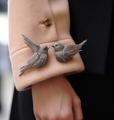 Silver bird sleeve brooch illustration made with Generative AI 