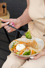 Salad with quinoa and salmon in female hands