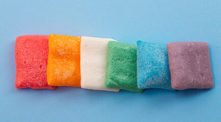Rainbow Freeze Dried Candy Fruit Flavored Bar Candies on a Blue Background