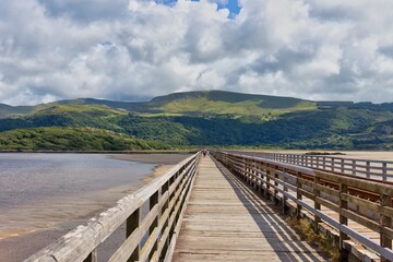 wooden bridge over the river with mountains landscape