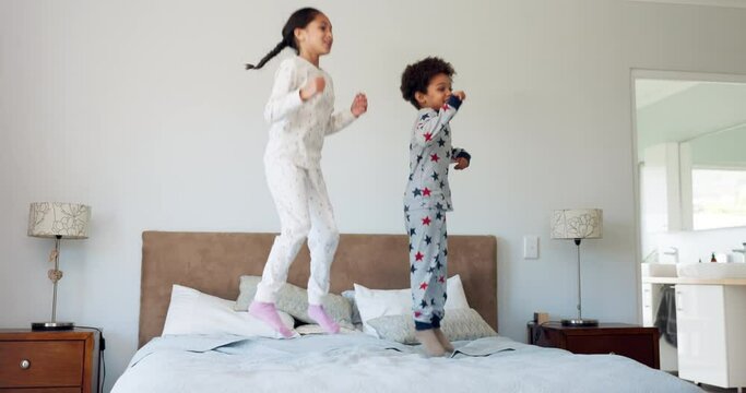 Happy, morning and jump with children in bedroom for energy, wake up and wow. Dance, happiness and fun with excited kids on bed in family home for celebration, freedom and playful together