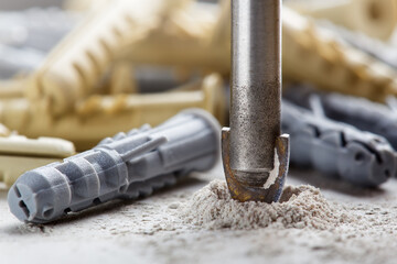 metal drill bit make holes in concrete wall on industrial drilling machine with shavings. Metal work industry