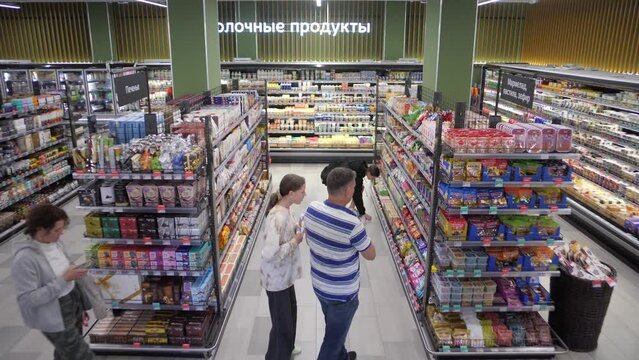 Timelapse in a large grocery hypermarket with rows full of products 