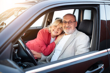 Fototapeta na wymiar Own Car. Portrait Of Happy Senior Couple Sitting In Their New Automobile