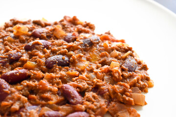 Chilli con carne on a white plate.  Traditional Mexican food. 