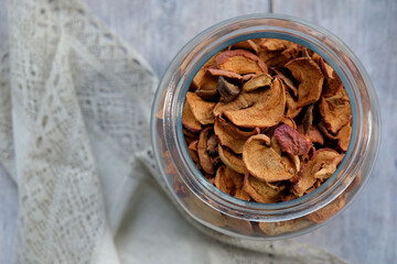 dried apples and pears in a glass jar on the table