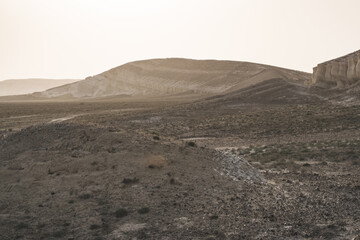 Panoramic view of the Kazakh steppe with ditches from the water and chalk slopes, the shape of limestones in the evening in the steppe