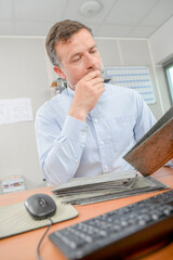 man calmly selecting tiles in office
