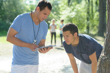 smiling man showing woman training