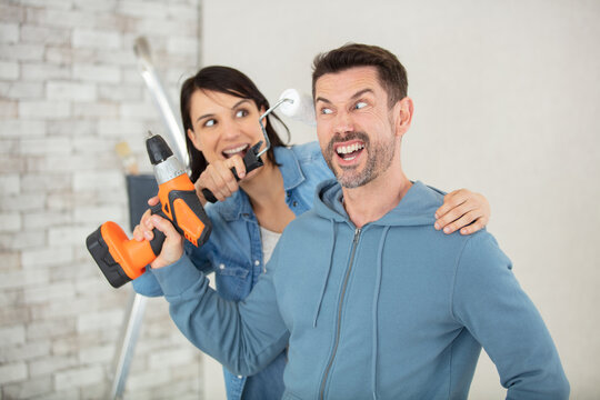 couple having fun while renovating their new home