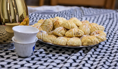 Arabic coffee and maamoul on arabic white shamgh