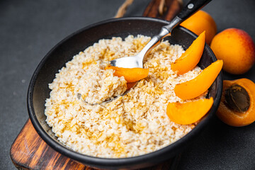 oatmeal porridge fresh apricot tasty breakfast healthy meal food snack on the table copy space food background rustic top view