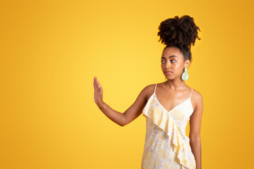 Unhappy confident offended millennial black lady in dress make stop gesture with hand