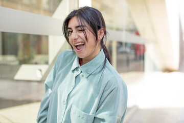 pretty woman with a big, friendly, carefree smile, looking positive, relaxed and happy, chilling