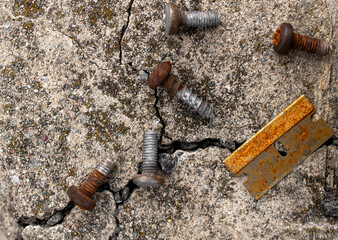 close up of rusty razor blade and screws 