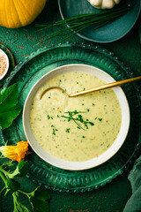 Tasty homemade zucchini and potato cream soup with  herbs