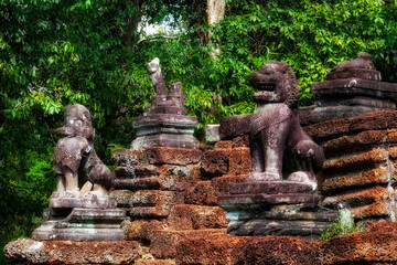 Lion sentinels: Ancient ruins in Cambodia protected by sculptures of guard lions.