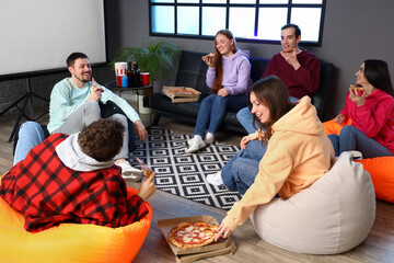 Group of friends with tasty pizza at home