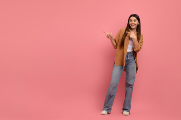 Fototapeta premium Nice Offer. Happy Teen Girl Pointing At Copy Space With Two Hands