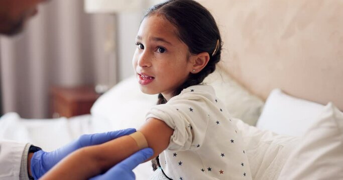 Home care, plaster and a child with a doctor for a vaccine, girl healthcare and consultation. House, medicine and hands of a medical employee with a bandage for a sick kid in the bedroom with covid