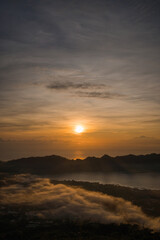 Fototapeta na wymiar Amazing sunrise lake view at mount Batur. Dawns landscape photo at foggy Batur mount with orange sky