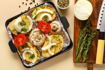 Baking dish with fresh raw vegetables, spices and rosemary on color background, closeup
