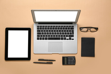 Fototapeta na wymiar Composition with laptop, eyeglasses and calculator on beige background