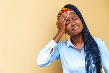 young African woman holding her head in her hands