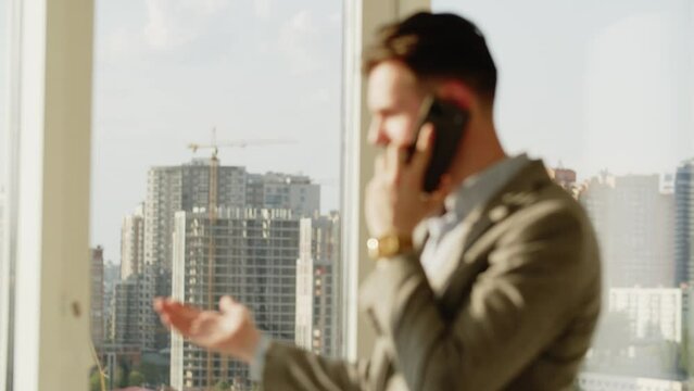 Young man's hands holding a modern smartphone. Businessman are angry and scream on his mobile phone. Something went wrong and man have problems at work . Conflict in relations