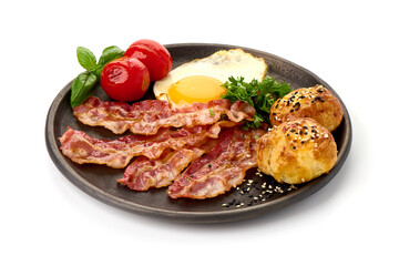 Cooked bacon rashers with egg, close-up, isolated on white background.