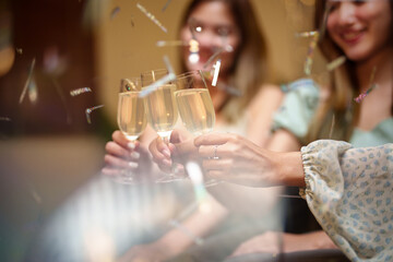 Group of friends celebrating with champagne  Close up on hands.