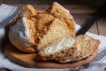 Traditional Irish soda bread made from whole grain and rye flour on a wooden table. Rustic style. - 632316845