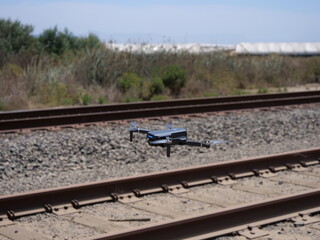 hovering drone on railroad tracks
