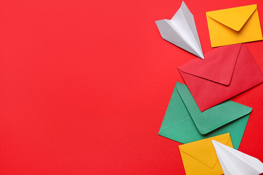 Set of different envelopes and paper planes on red background