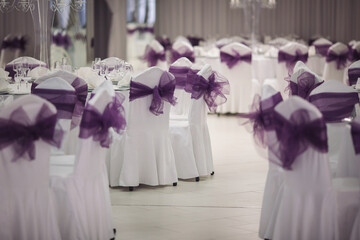 wedding chairs and details on summer wedding. ceremony decorations in restaurant. Elegant decoration of wedding ceremony outdoor. Wedding banquet with beautiful white furniture. 
