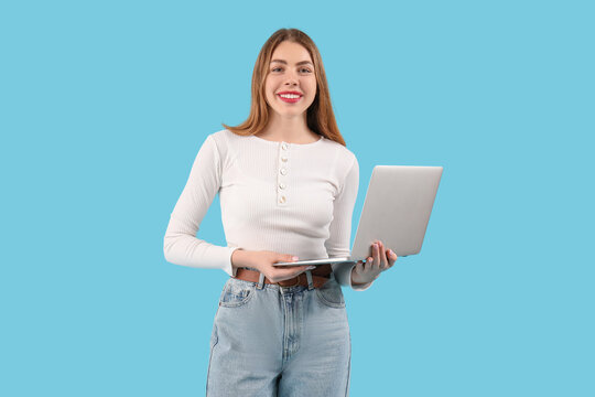 Female programmer with laptop on blue background