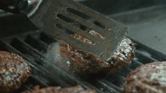 Hamburger on grill in slow motion