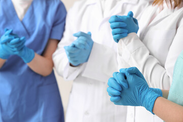 Doctors in medical gloves at clinic, closeup