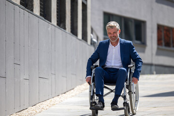 Fototapeta na wymiar Disabled handsome man on wheelchair outdoor.