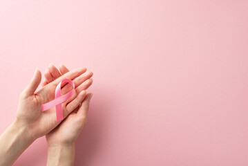 International Breast Cancer Awareness Month concept. High-angle view photo of woman's hands holding...