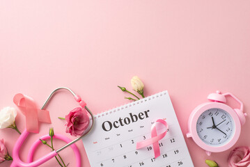 Breast cancer awareness theme. Top view of October calendar, pink ribbon, stethoscope, alarm clock,...