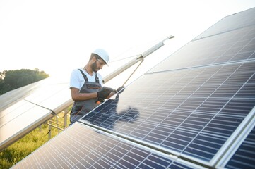An Indian worker installs solar panels. The concept of renewable energy.